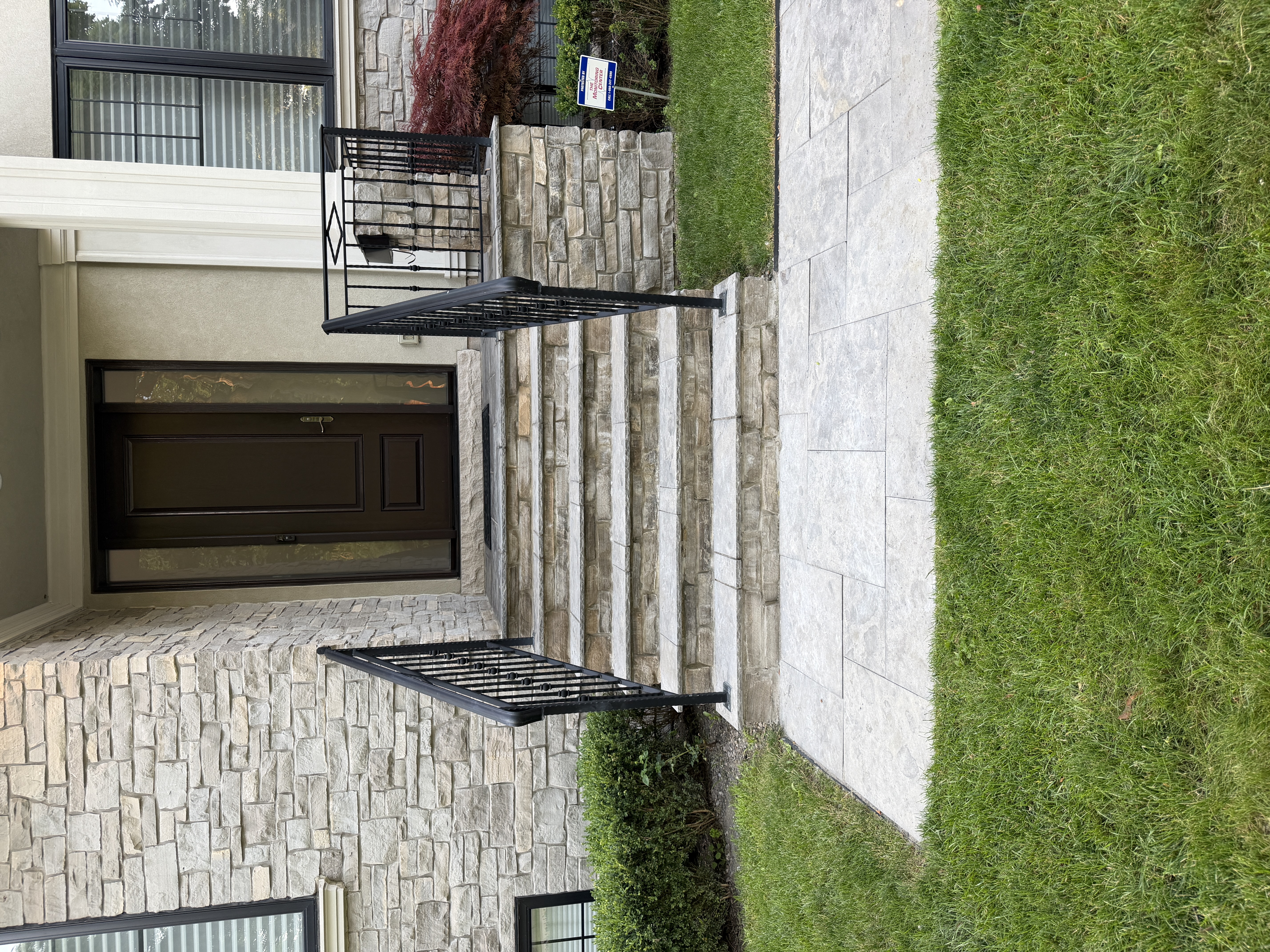 Natural stone front entrance steps with railings in Etobicoke