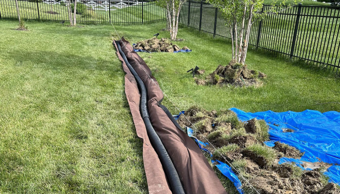 French drain installation across a backyard lawn in Etobicoke
