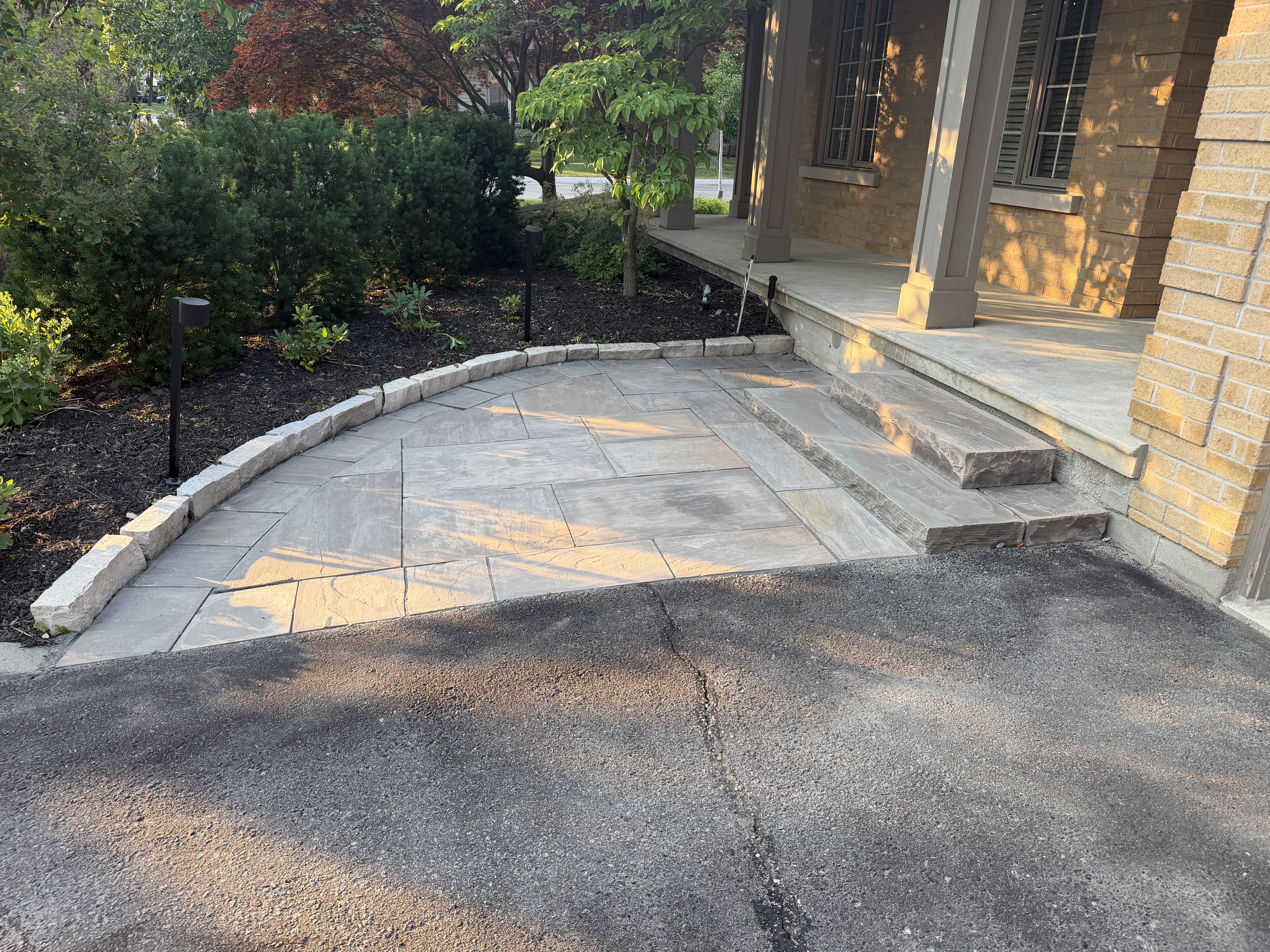 Curved stone patio and entry steps in Etobicoke