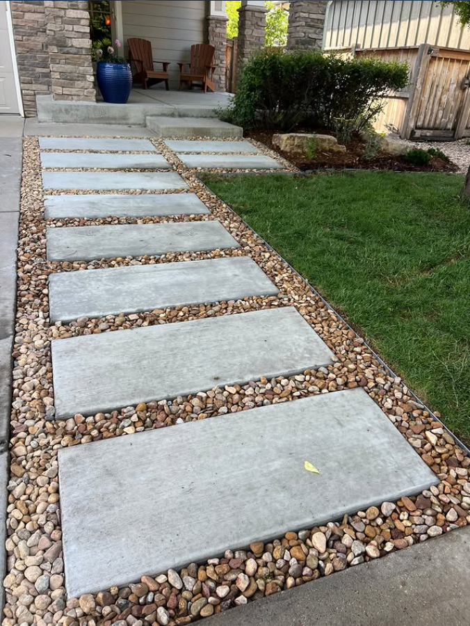 Concrete stepping stone walkway with river rock border in Etobicoke