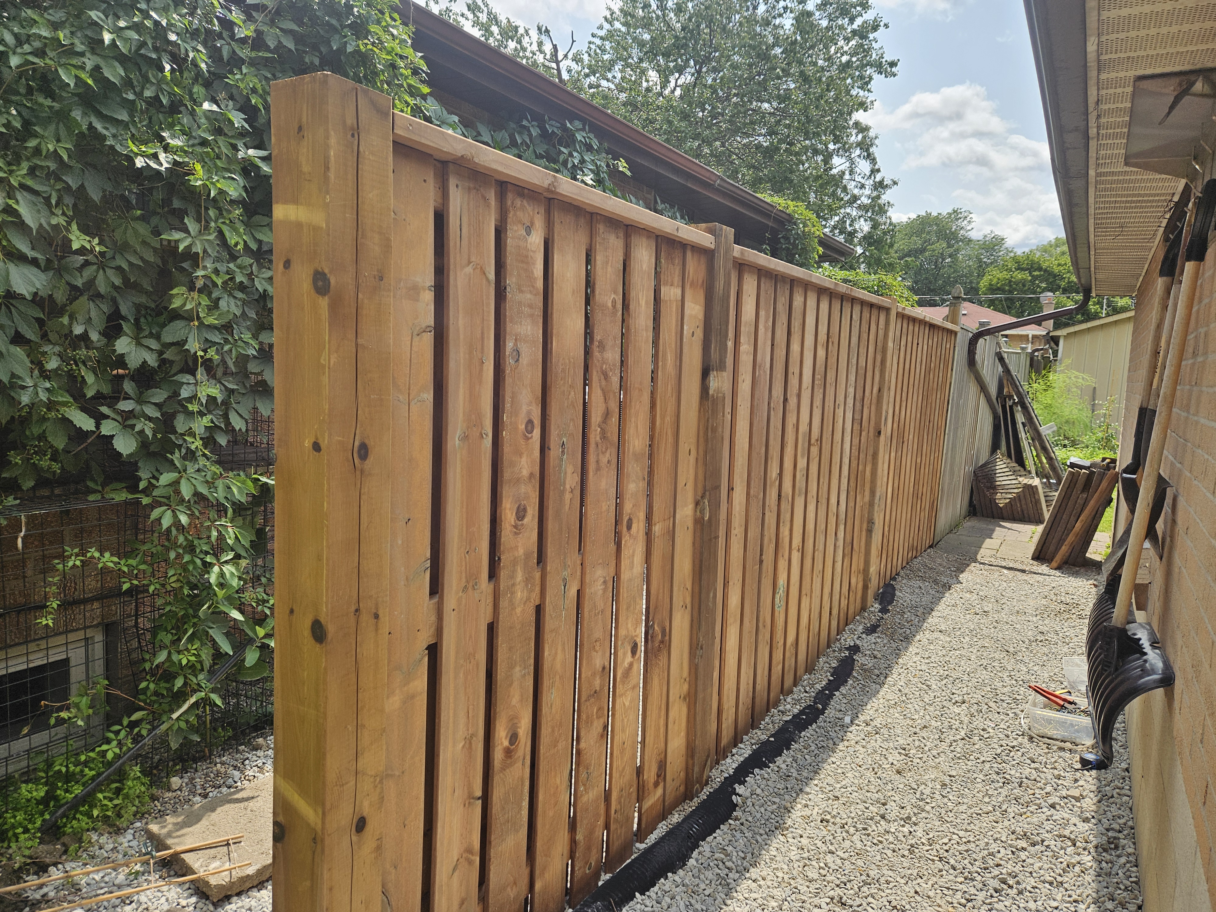 New wood privacy fence installation along a side yard in Etobicoke