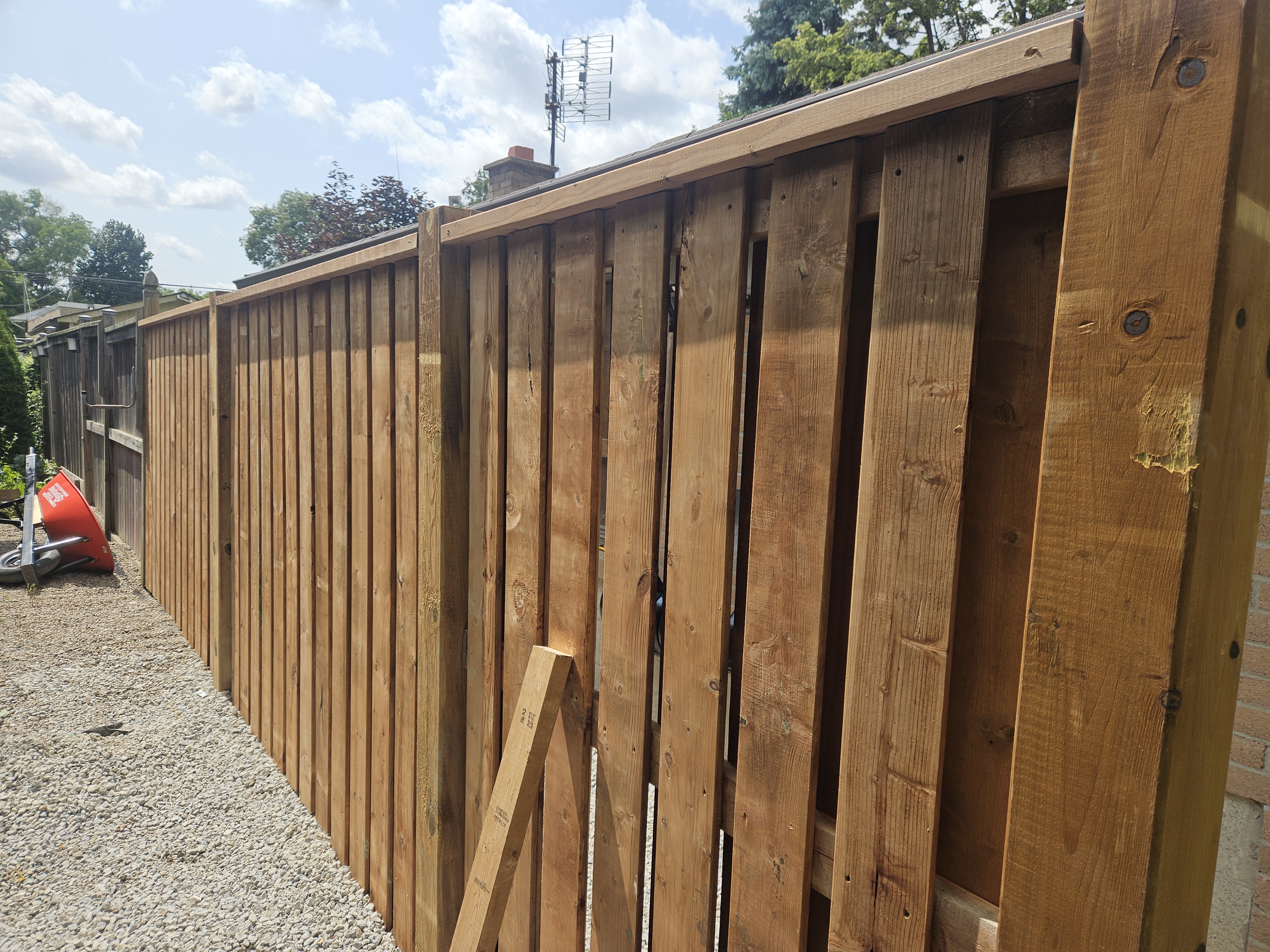 Wood fence installation in progress in Etobicoke